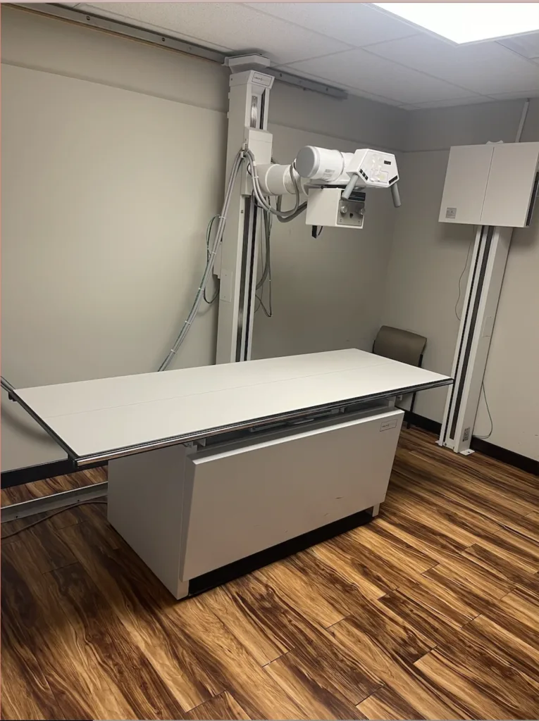 An X-ray examination table and imaging equipment in a clinic room